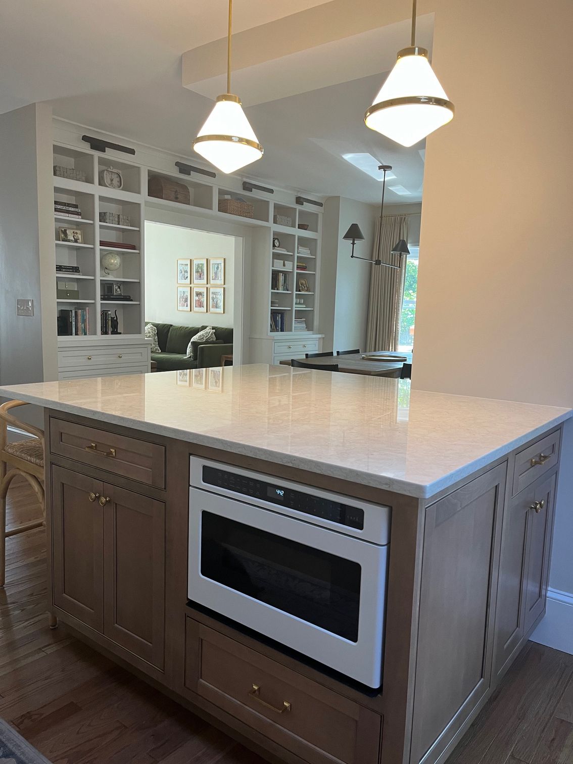 A kitchen with a large island and a microwave oven.