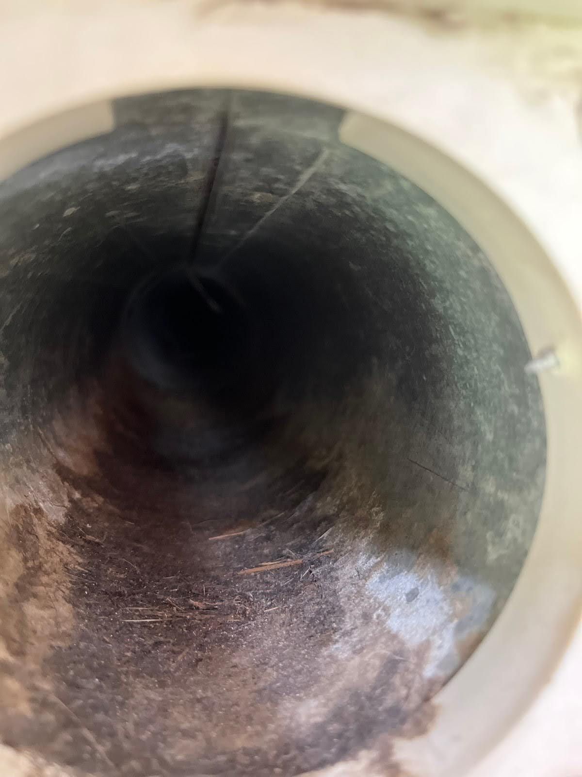 A close up of the inside of a clean duct with a light shining on it.