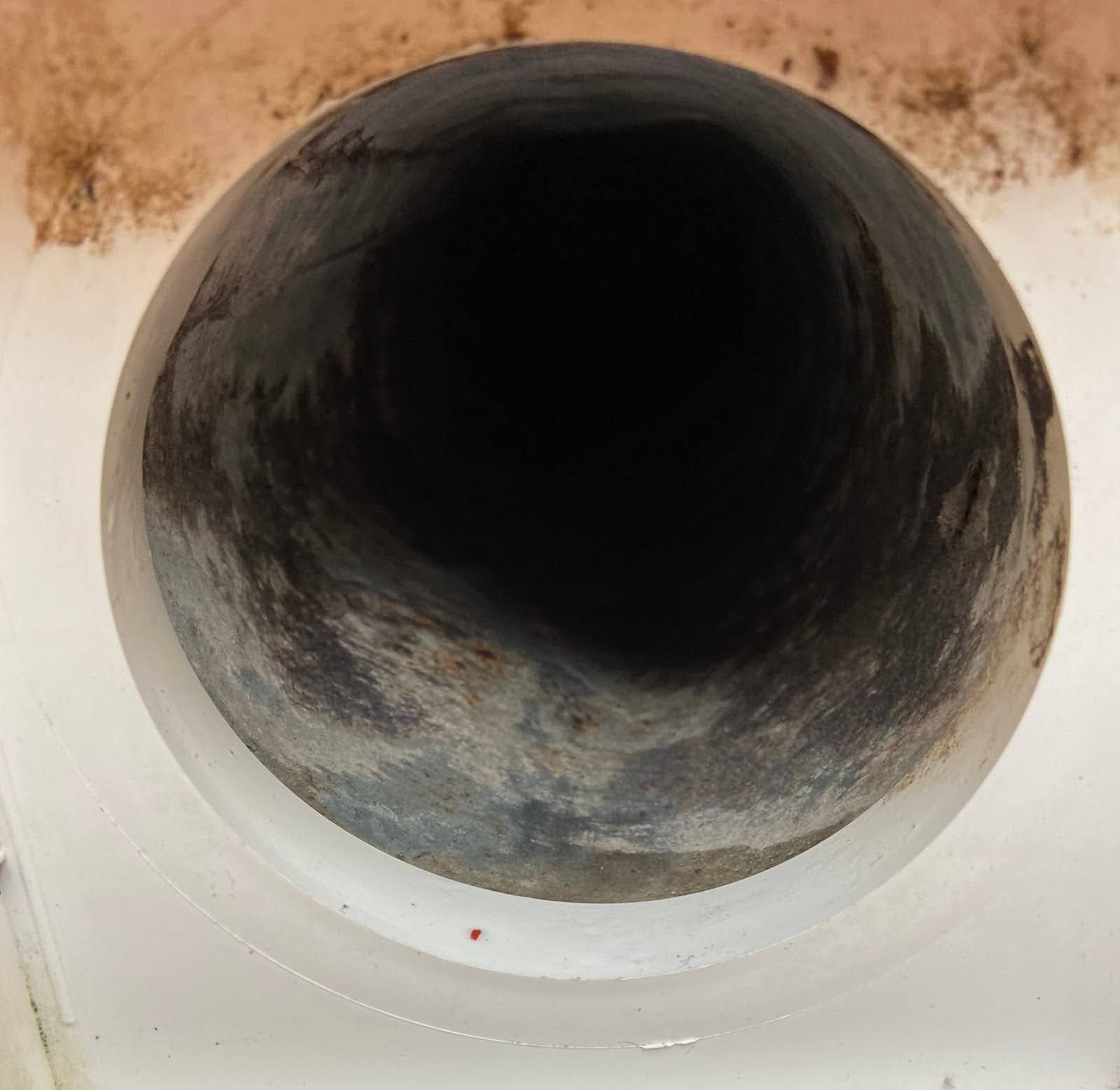 A close up of the inside of a clean duct with a light shining on it.