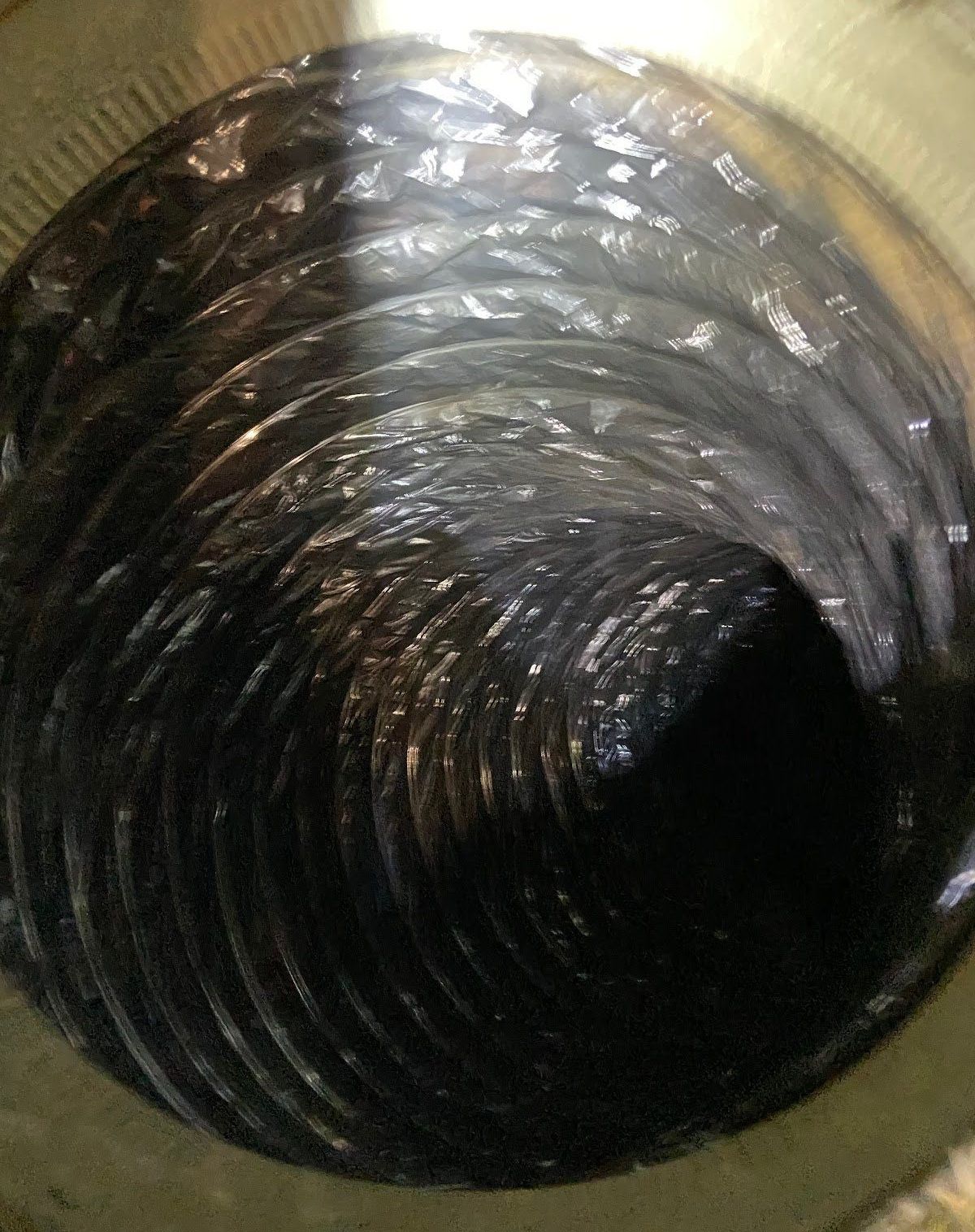 A close up of the inside of a clean duct with a light shining on it.