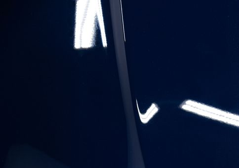 Abstract dark blue image with bright white streaks and a curved dark shape