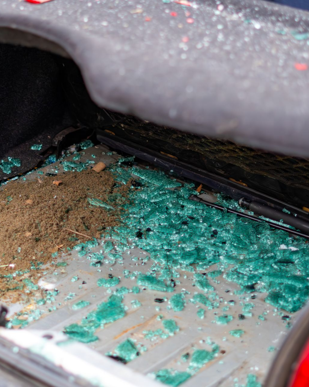 Green circuit board with scattered debris and brown dust inside a device casing