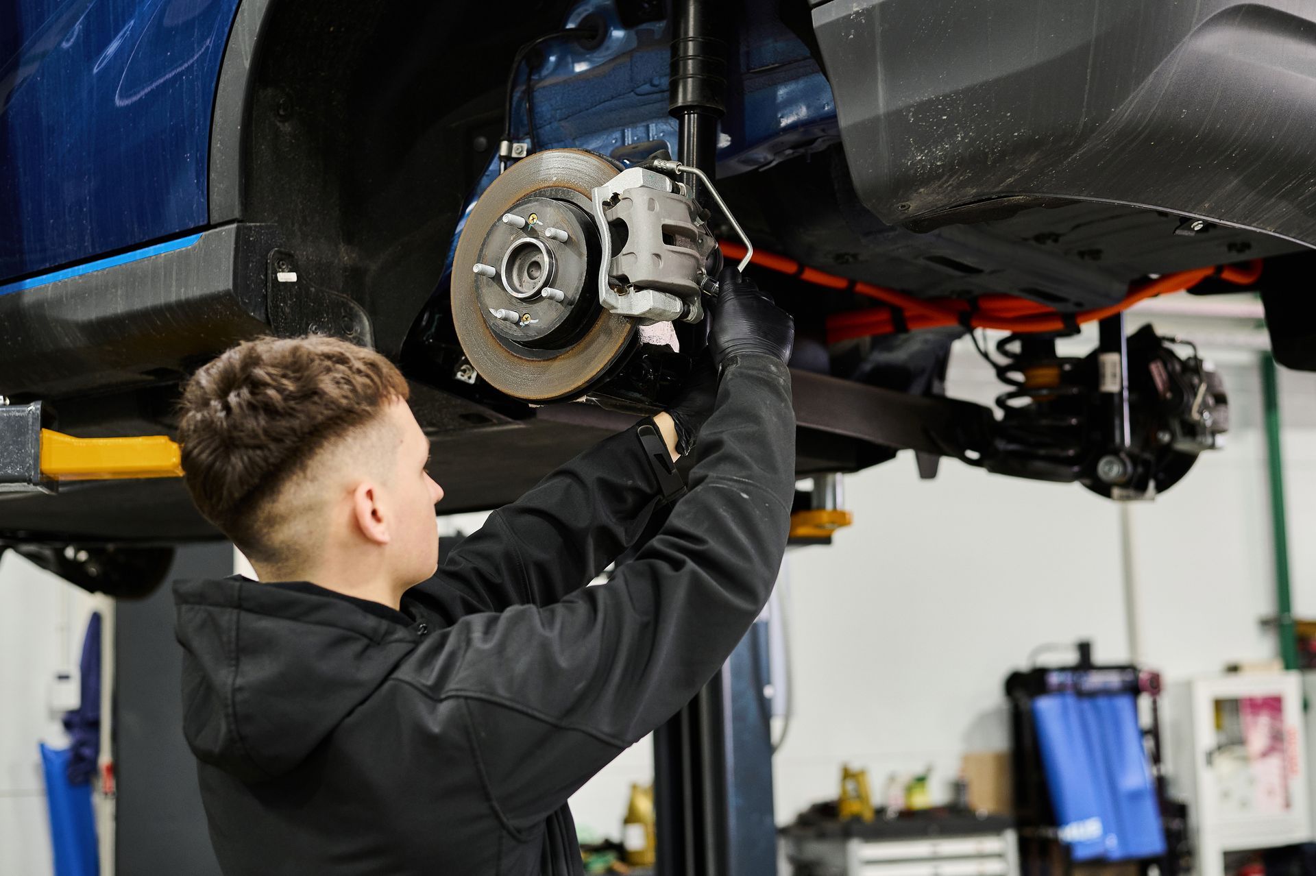 Mechanic working on brake disc | Two Guyz Automotive