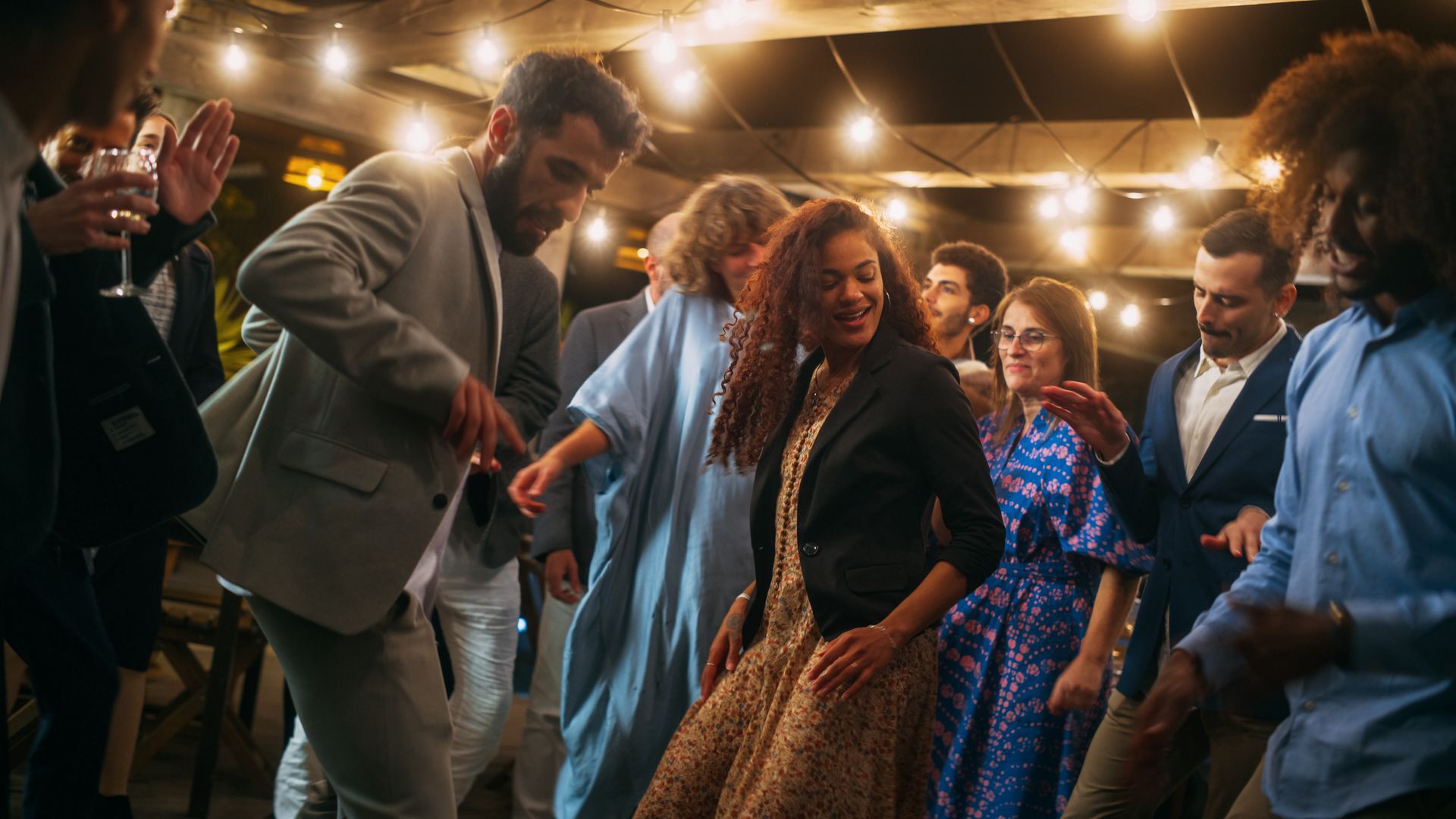 A group of people are dancing at a party.