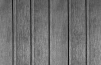 Gray weathered wooden planks arranged vertically with narrow black gaps