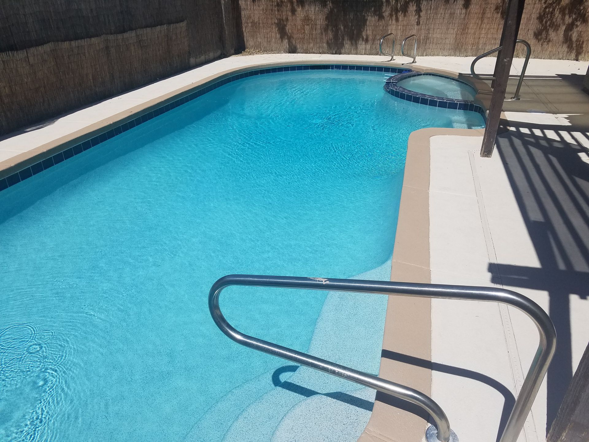 A large swimming pool with stairs leading to it