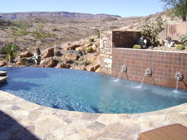 A large swimming pool with a view of the desert