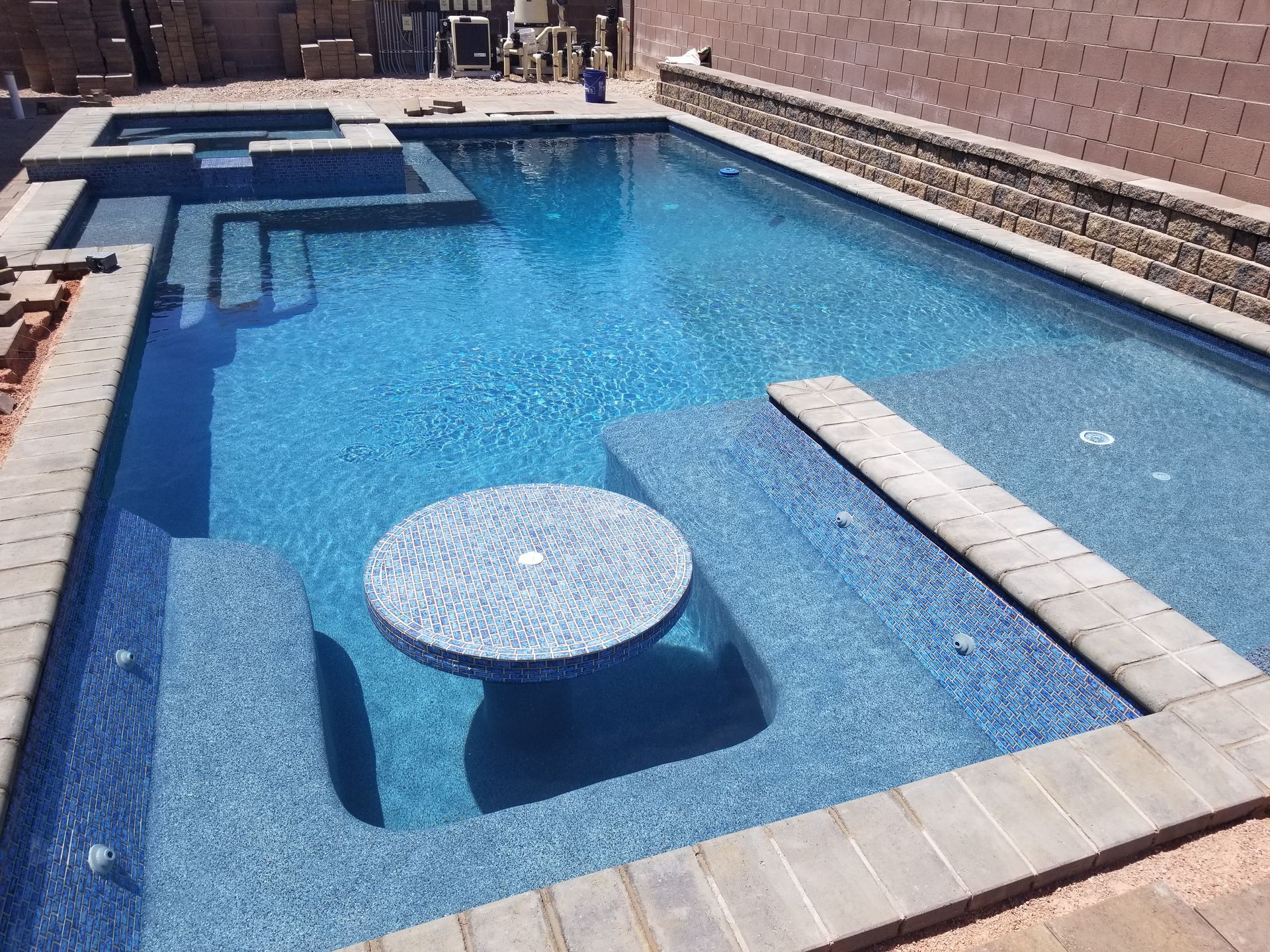 A large swimming pool with a table in the middle of it.