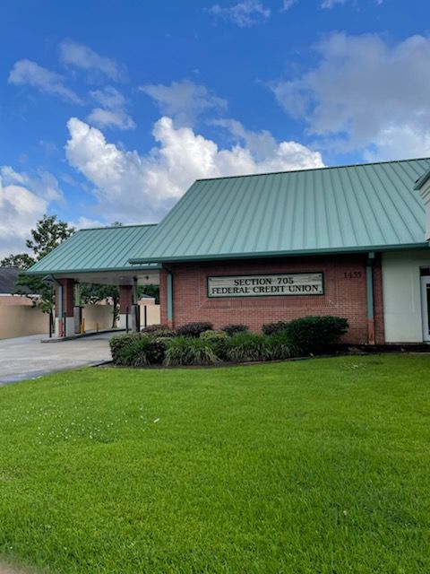Exterior view of Southern Tire Federal Credit Union building with green roof and sign.