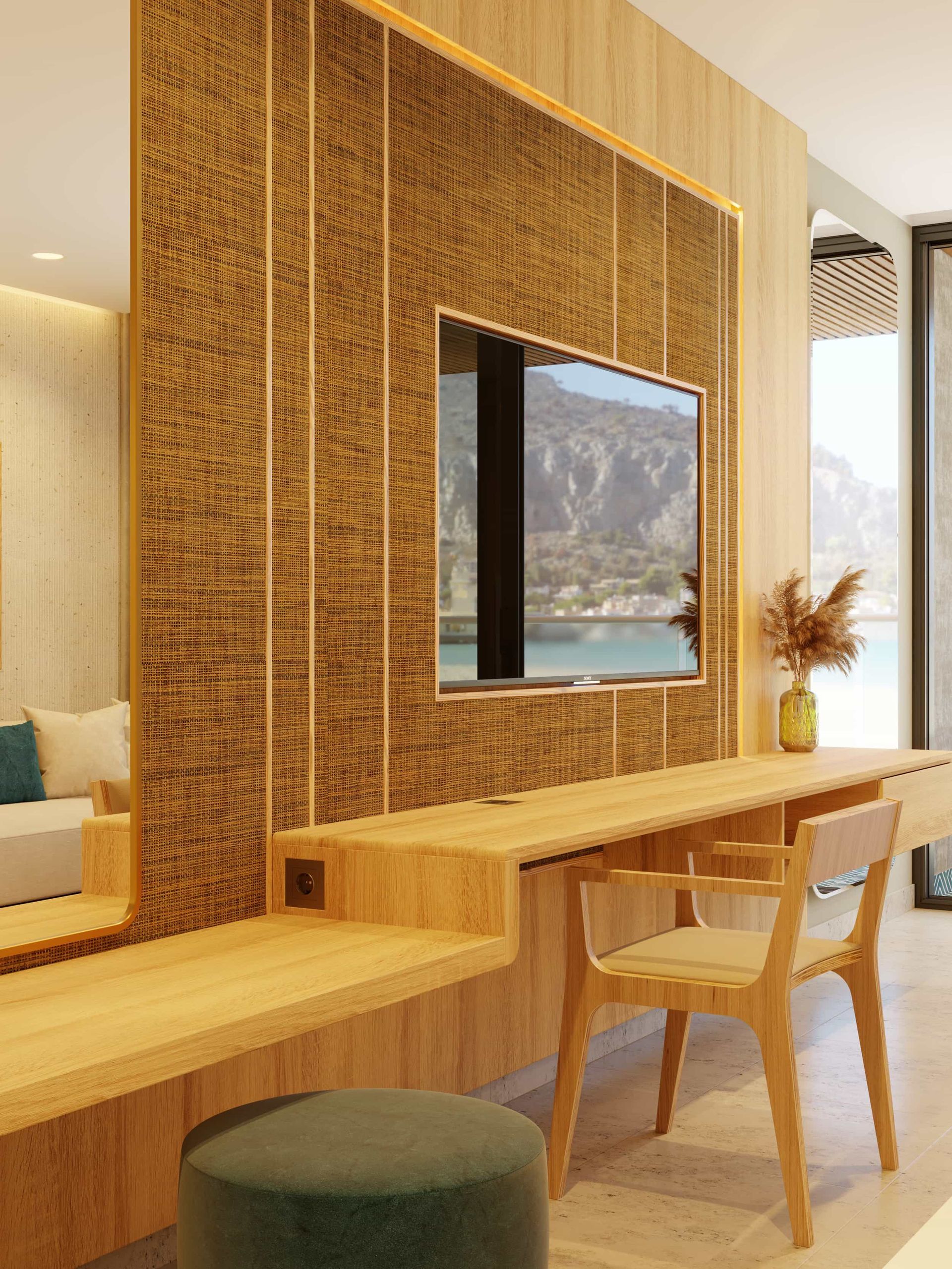 A modern hotel room with wooden desk, TV, mirror, and chair, overlooking a scenic view.