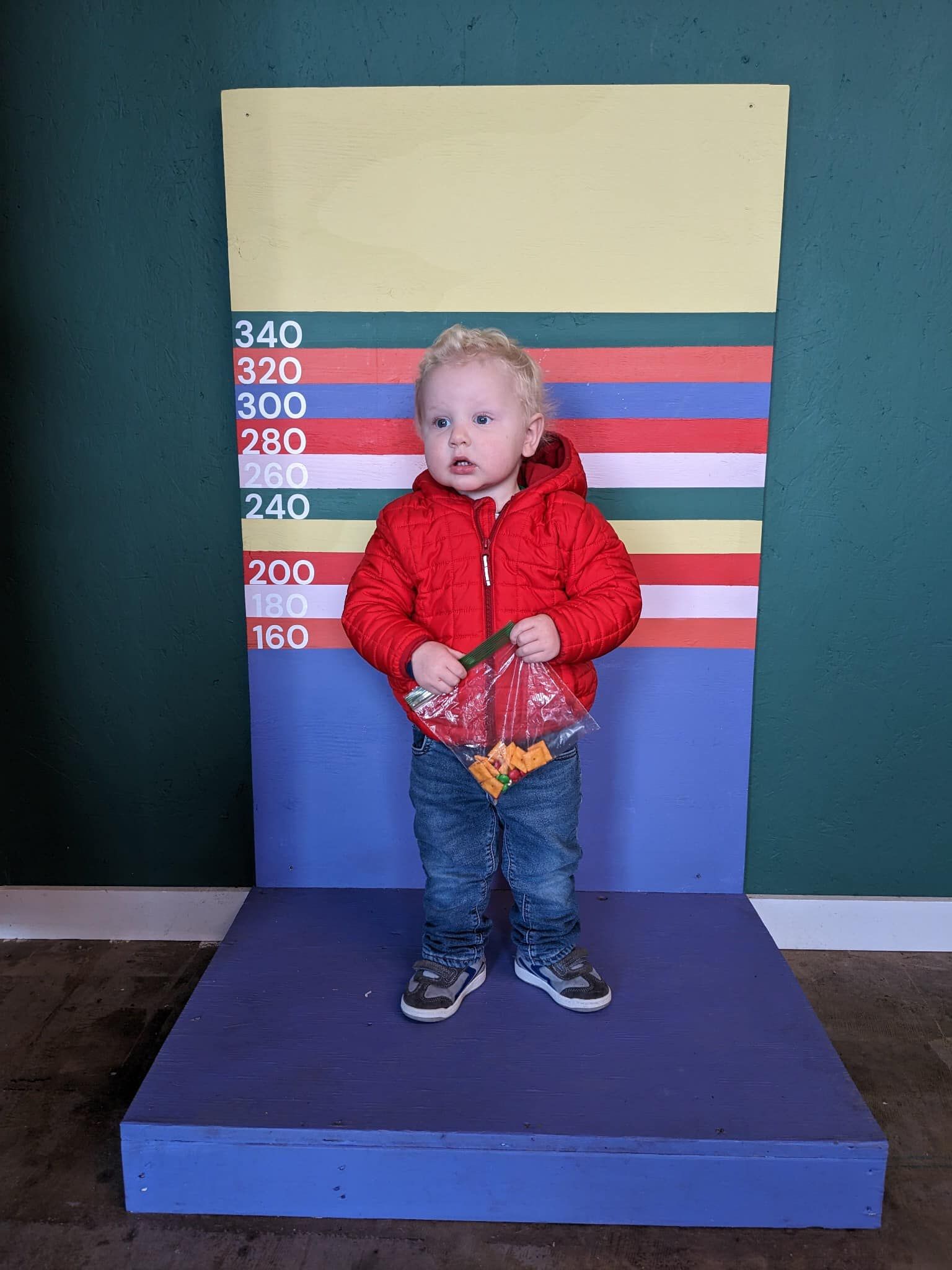 Child standing on Can-0-Meter for measuring bag of cans