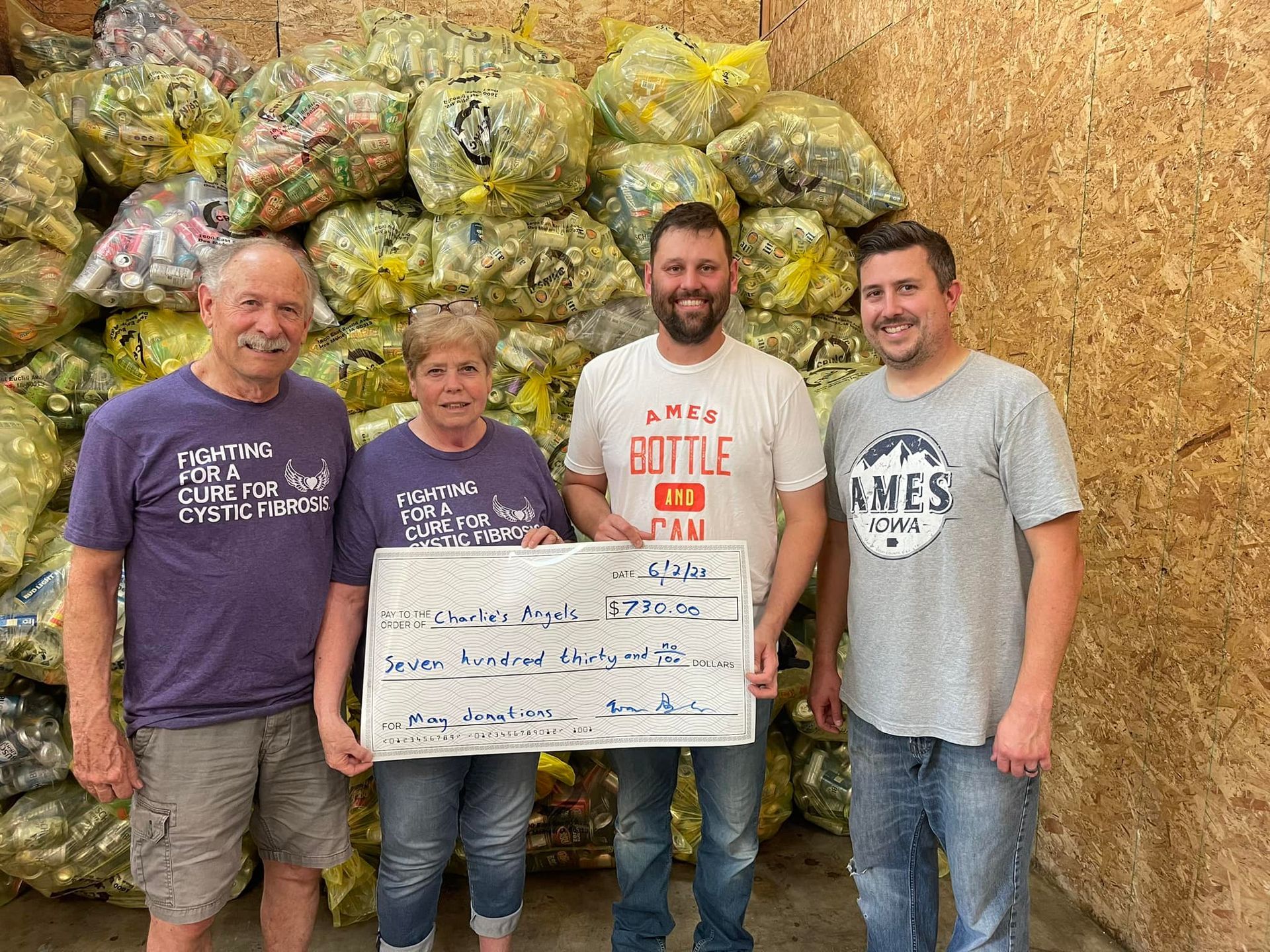 Evan Burger JL Vaughn and two non-profit representatives check presentation
