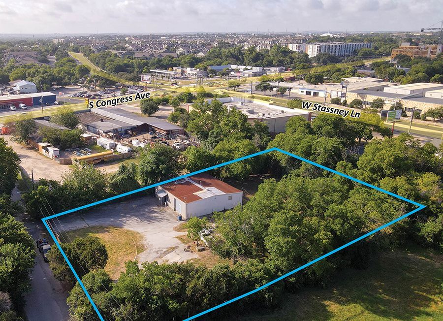 An aerial view of a building with a blue line around it