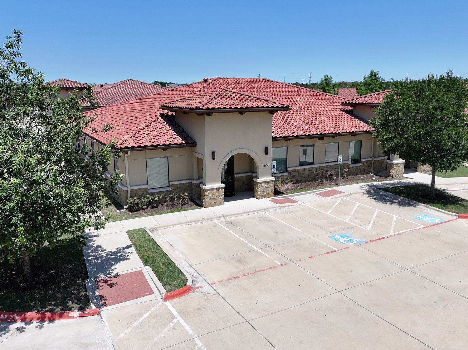 A large building with a handicapped parking spot in front of it.