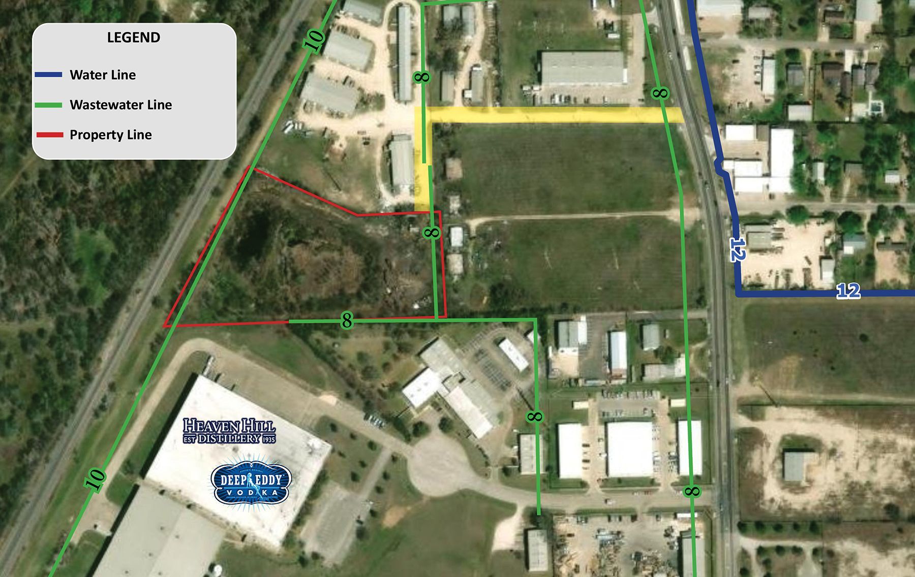 Aerial map of a site with colored route lines, roads, buildings, and fields