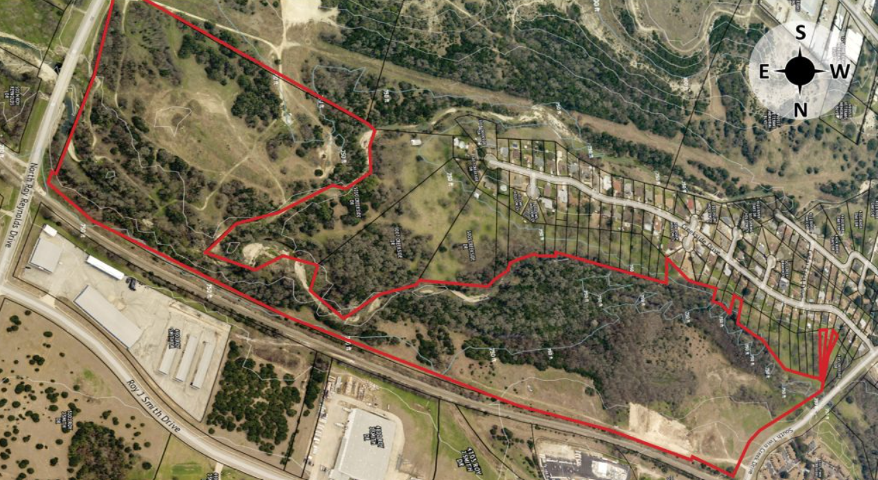 an aerial view of a residential area with a red line .