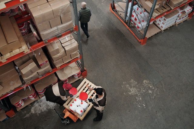 a group of people are working in a warehouse .