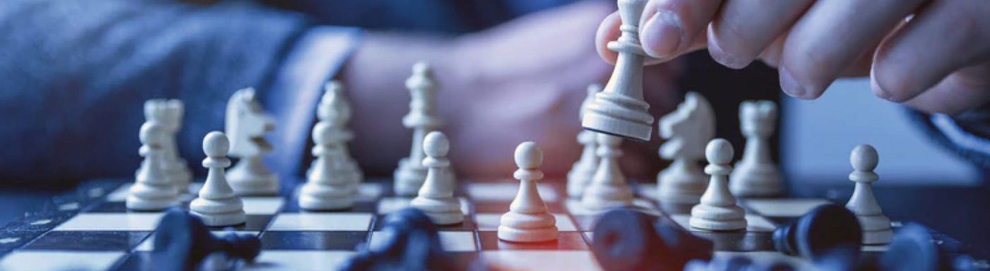 a person is playing a game of chess on a chess board .