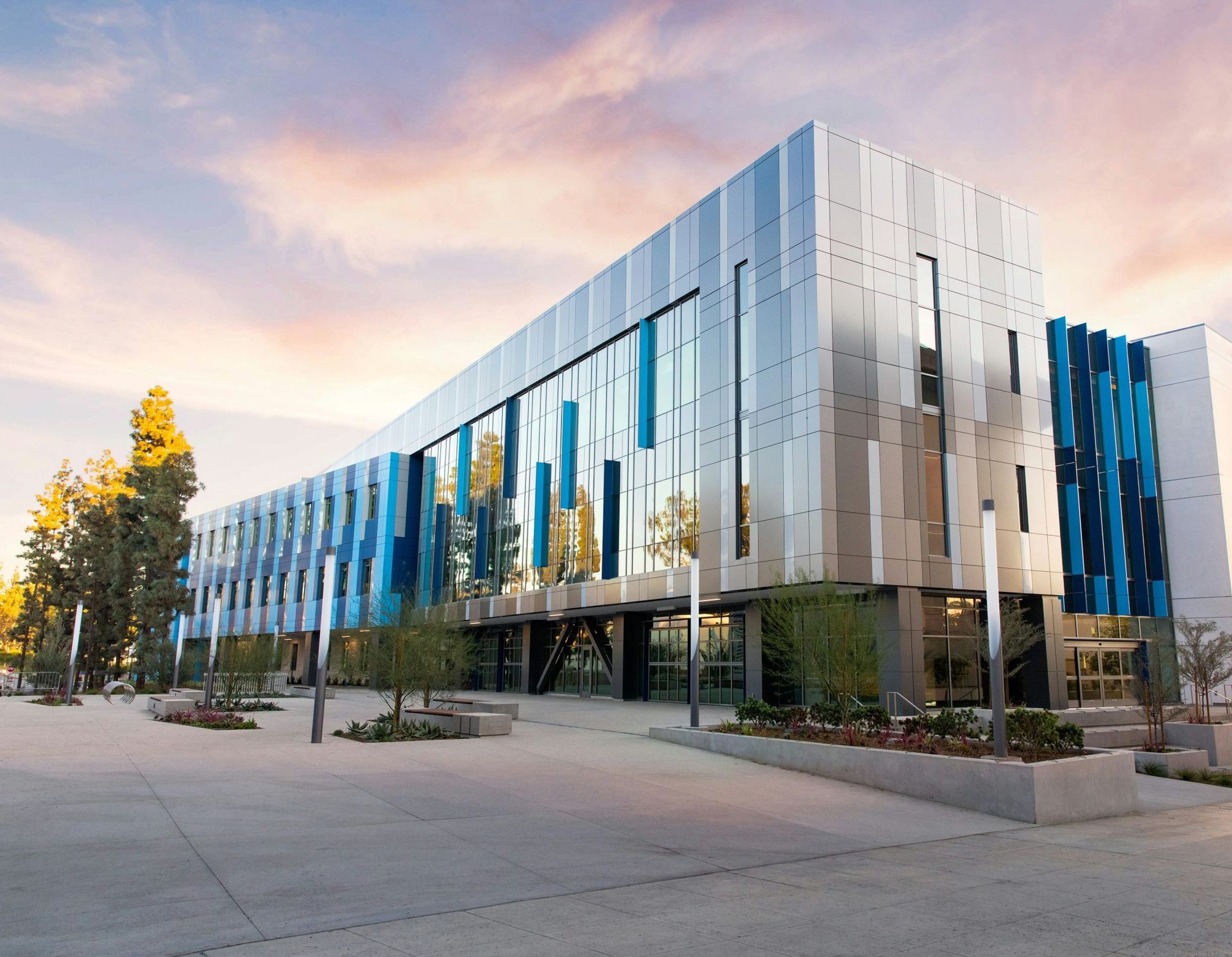 a large building with a lot of windows and trees in front of it .