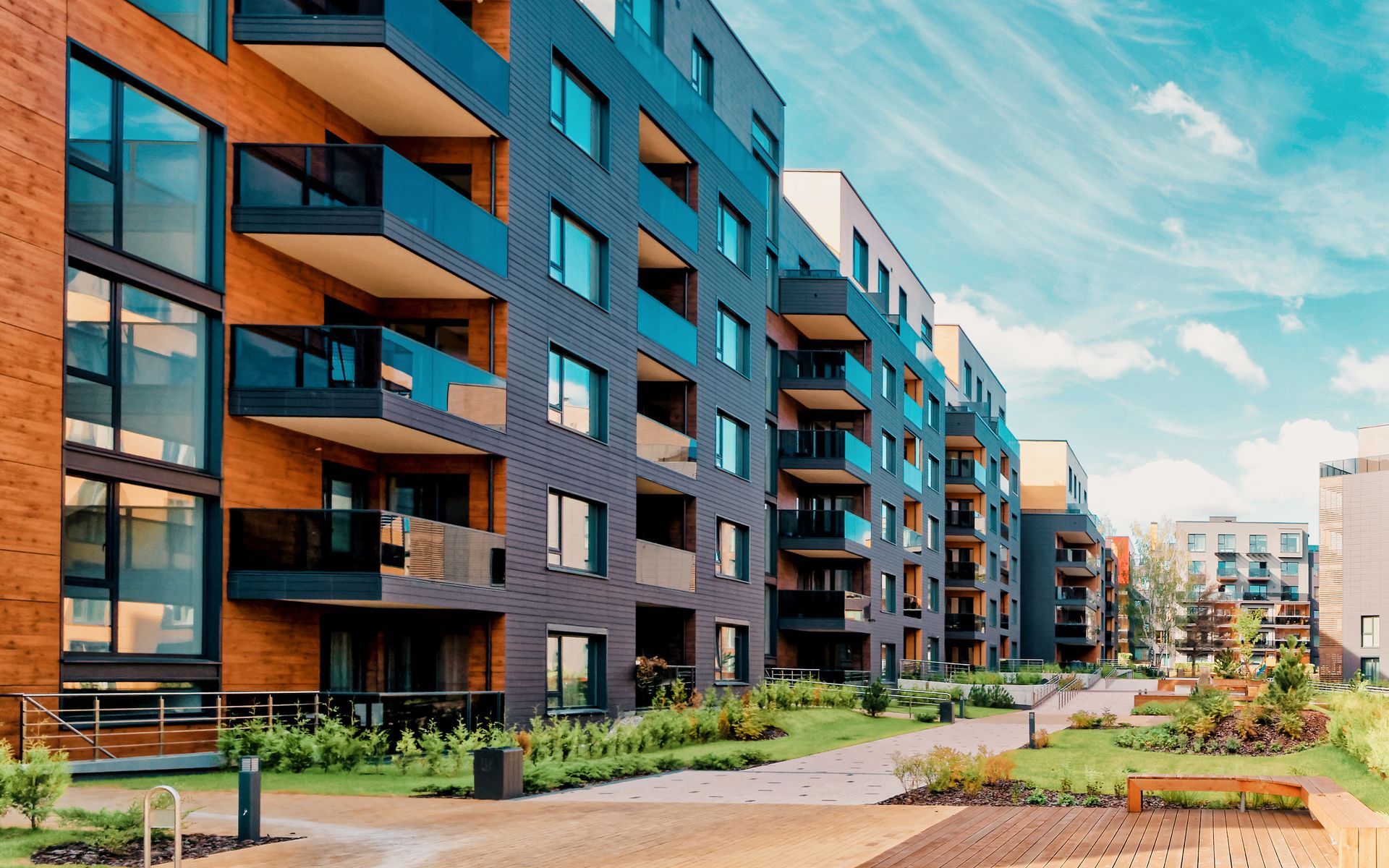 A row of apartment buildings with balconies in a residential area.