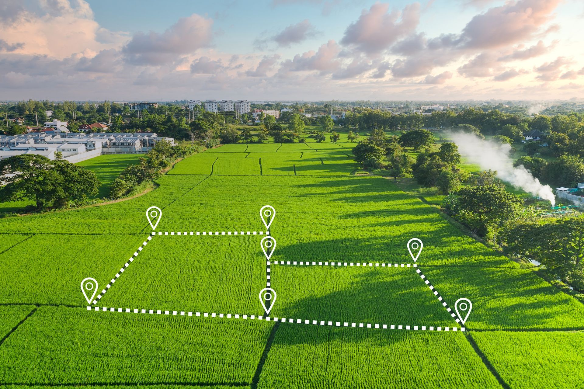 An aerial view of a green field with a map drawn on it.