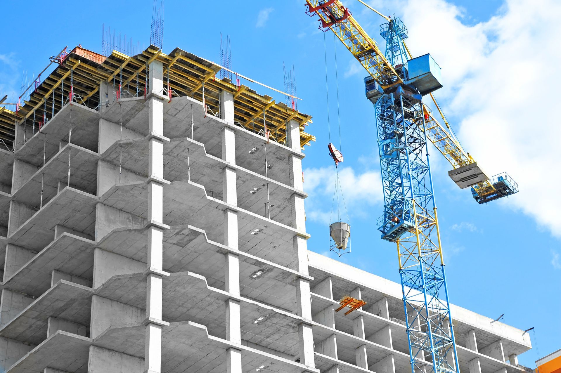 A building under construction with a crane in the foreground