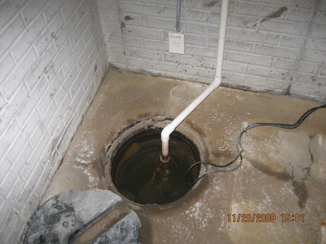 Unfinished basement wall framing with insulation, exposed plumbing, and concrete floor