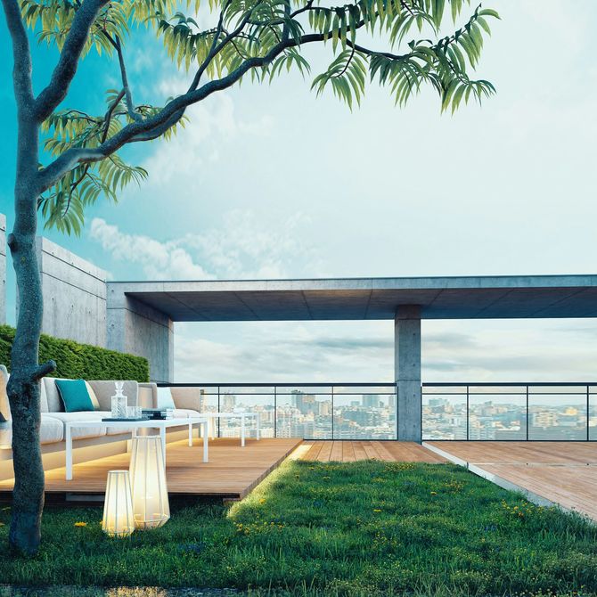 Modern rooftop patio with white sofa, lawn, tree, and city skyline view