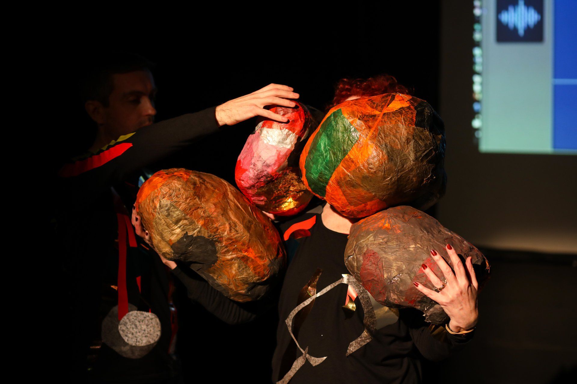 A group of people wearing colorful masks on their faces.