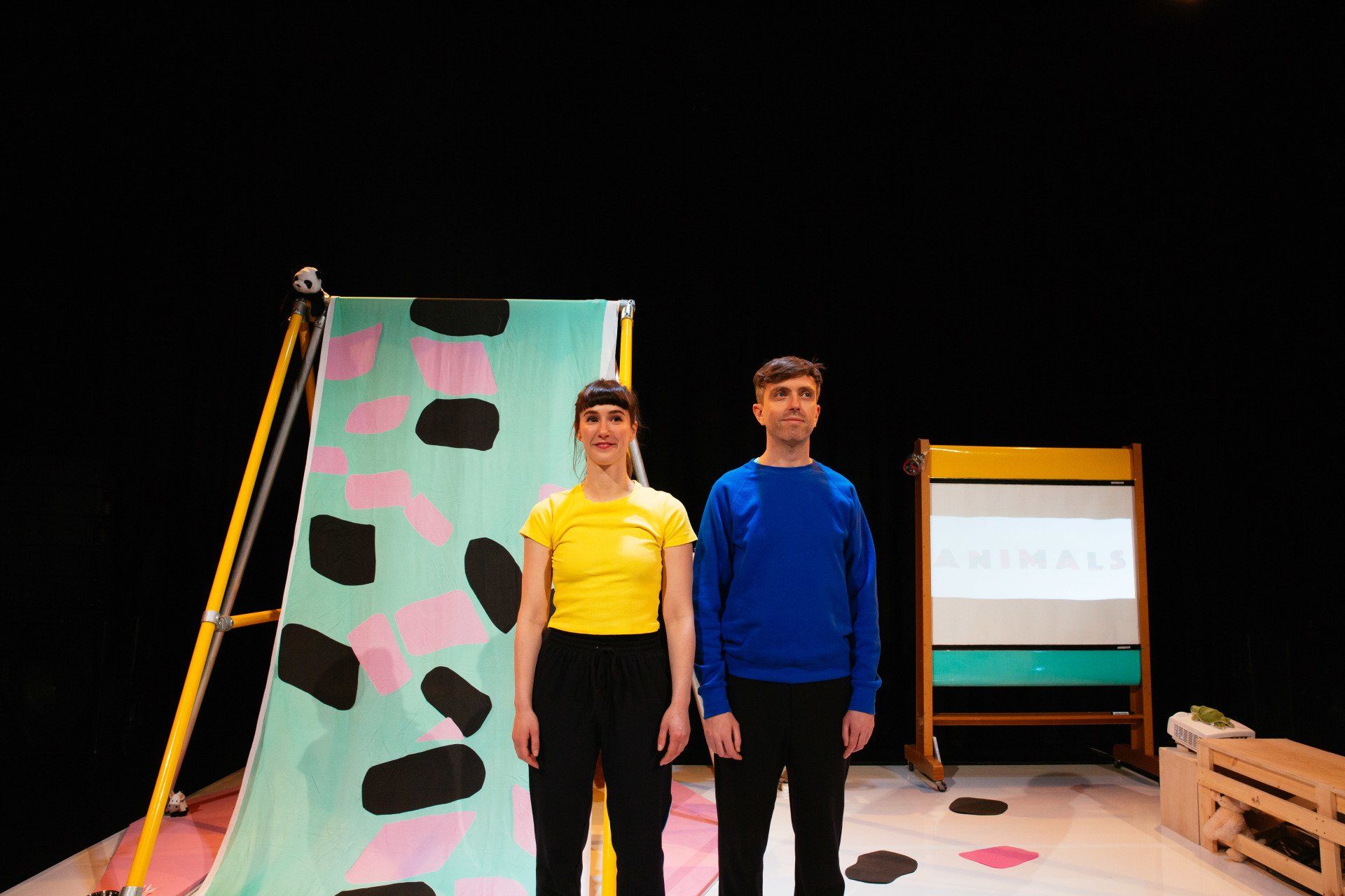 A man and a woman are standing next to each other on a stage.