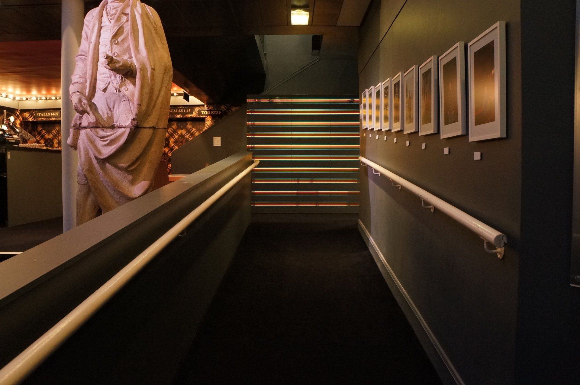 A long hallway with a statue in the background
