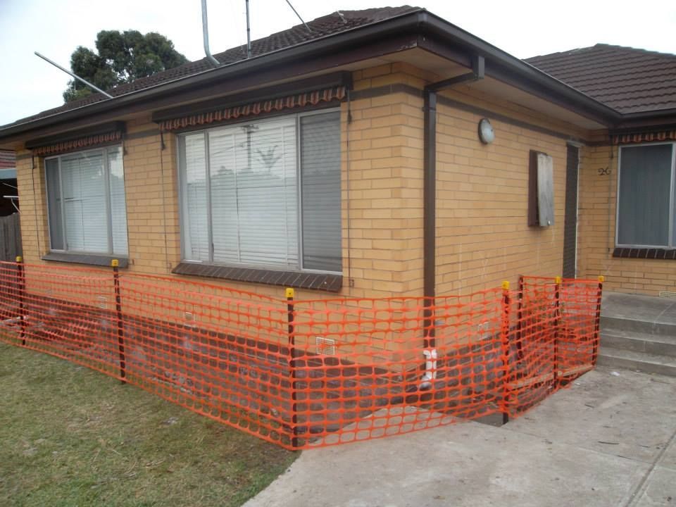 Brick House with Fence — Melbourne, VIC — Special Reblocking Services