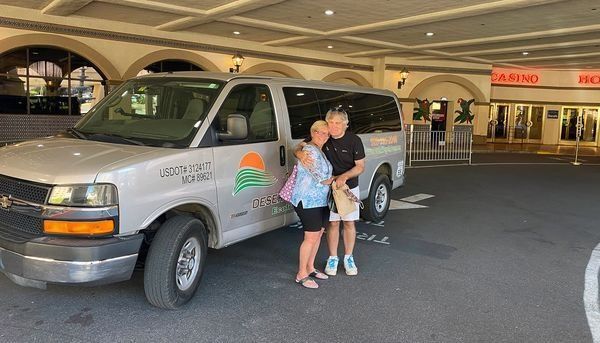 A man and a woman are standing in front of a van.