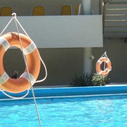 A life preserver is hanging over a swimming pool