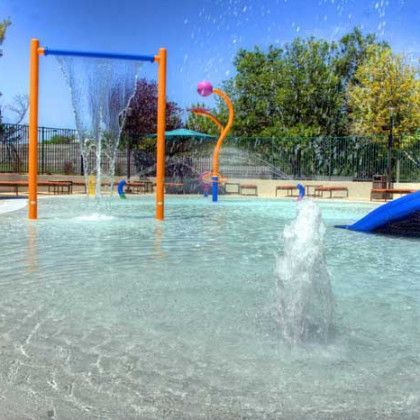 A water park with a slide and a water fountain