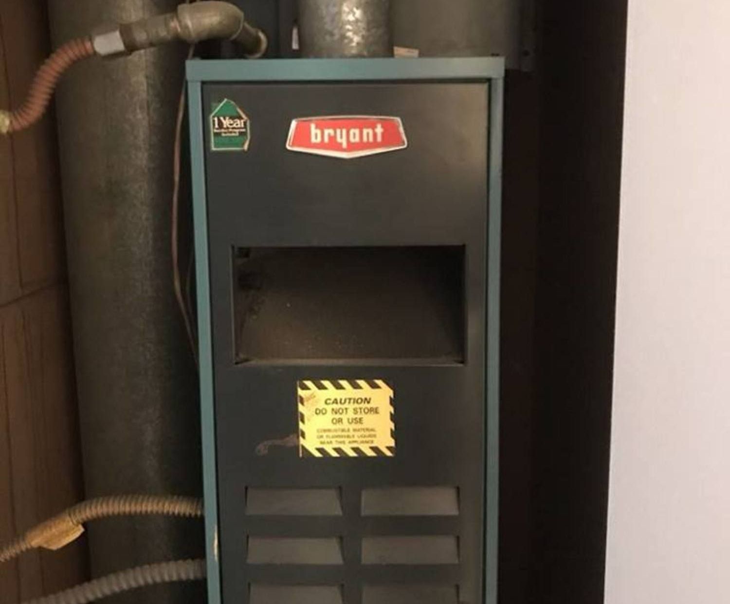 a bryant heater is sitting in a corner of a room