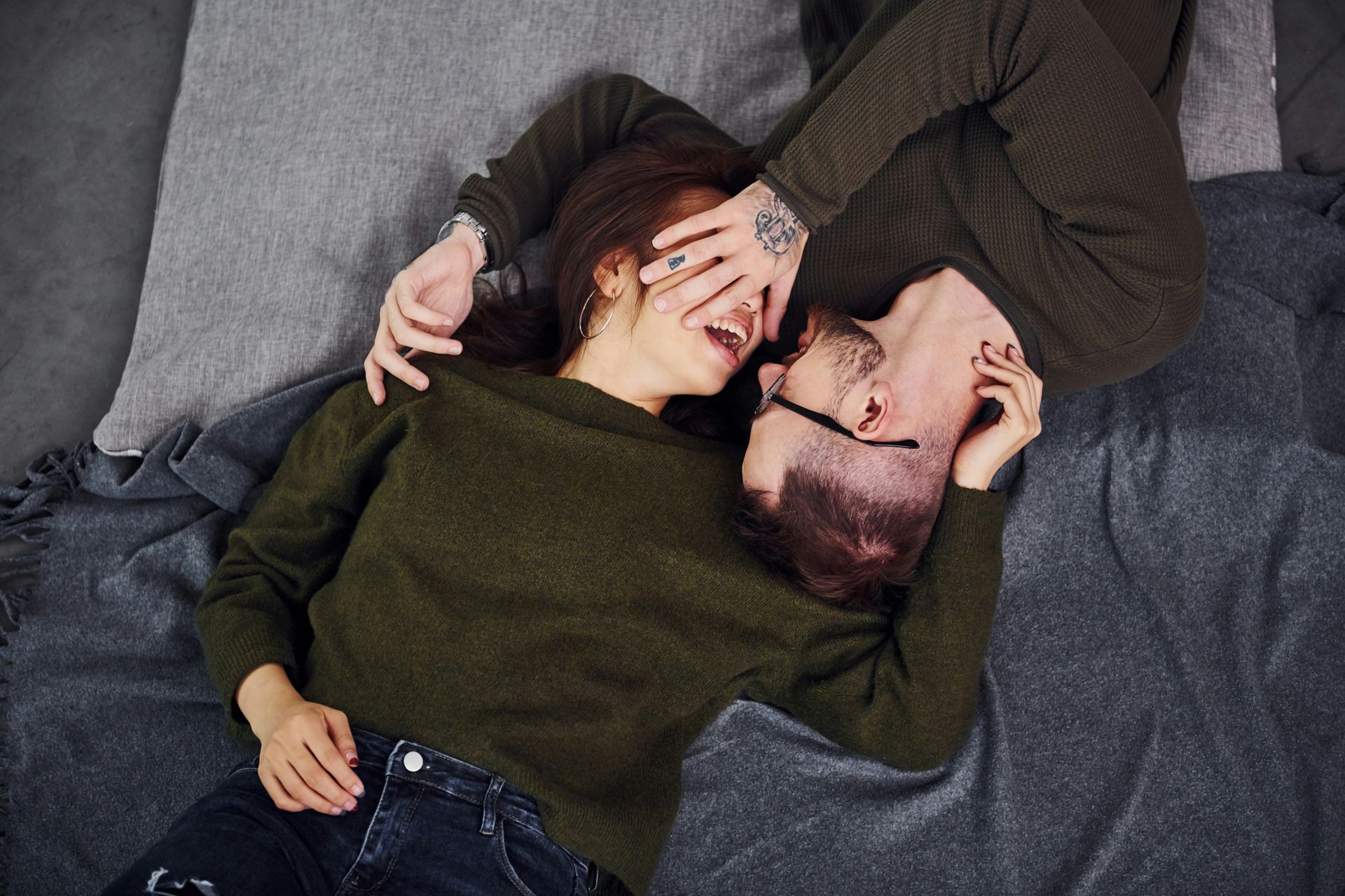A couple cradle each other's faces and contemplating going to couples therapy.