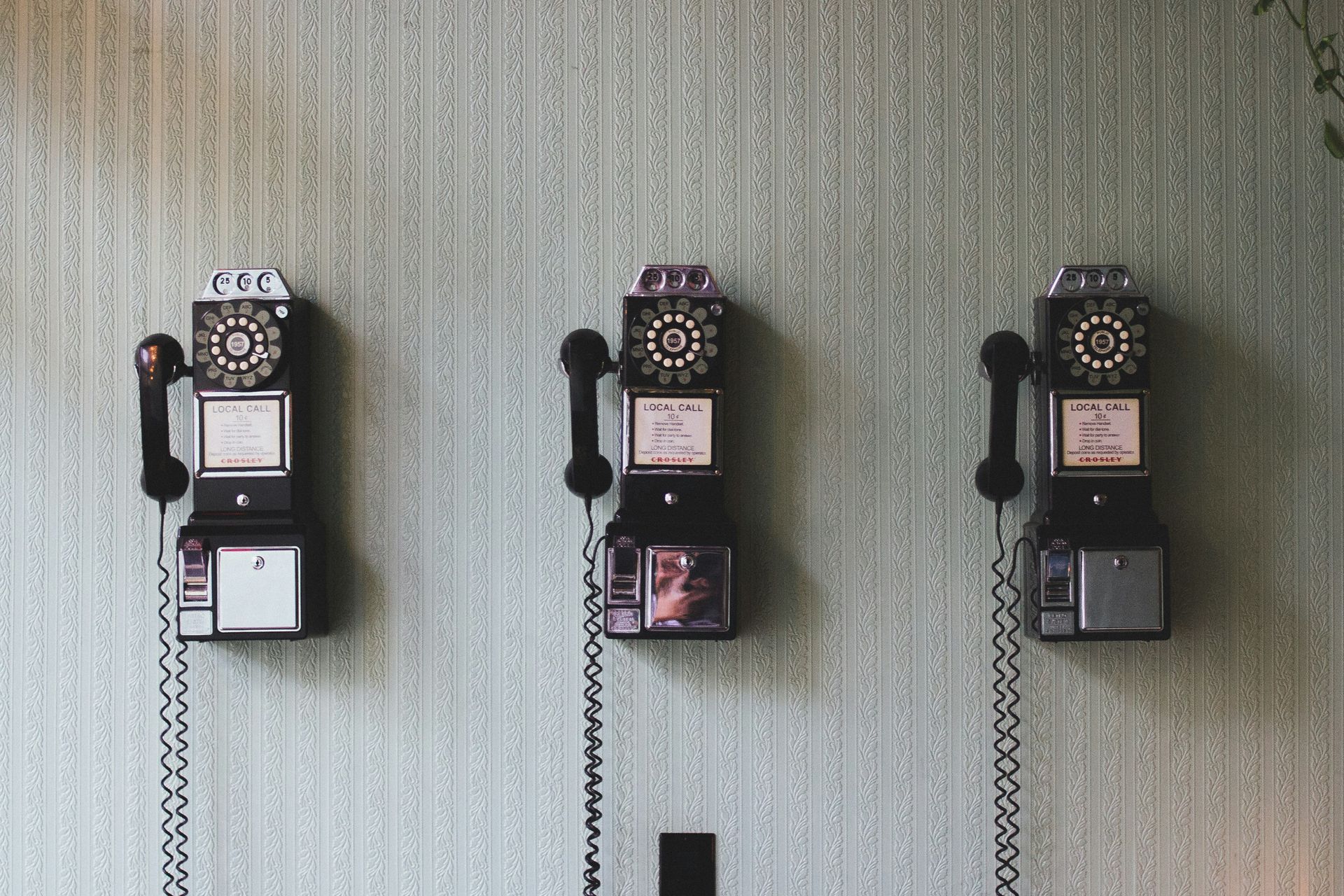 Three telephones symbolize a non-monogamous relationship.