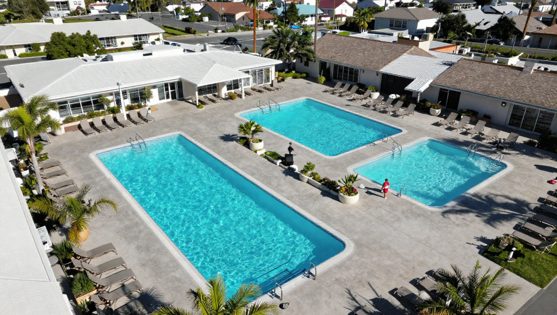 A man is cleaning a swimming pool with a net