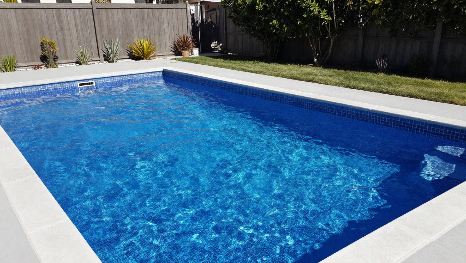 A man is cleaning a swimming pool with a net