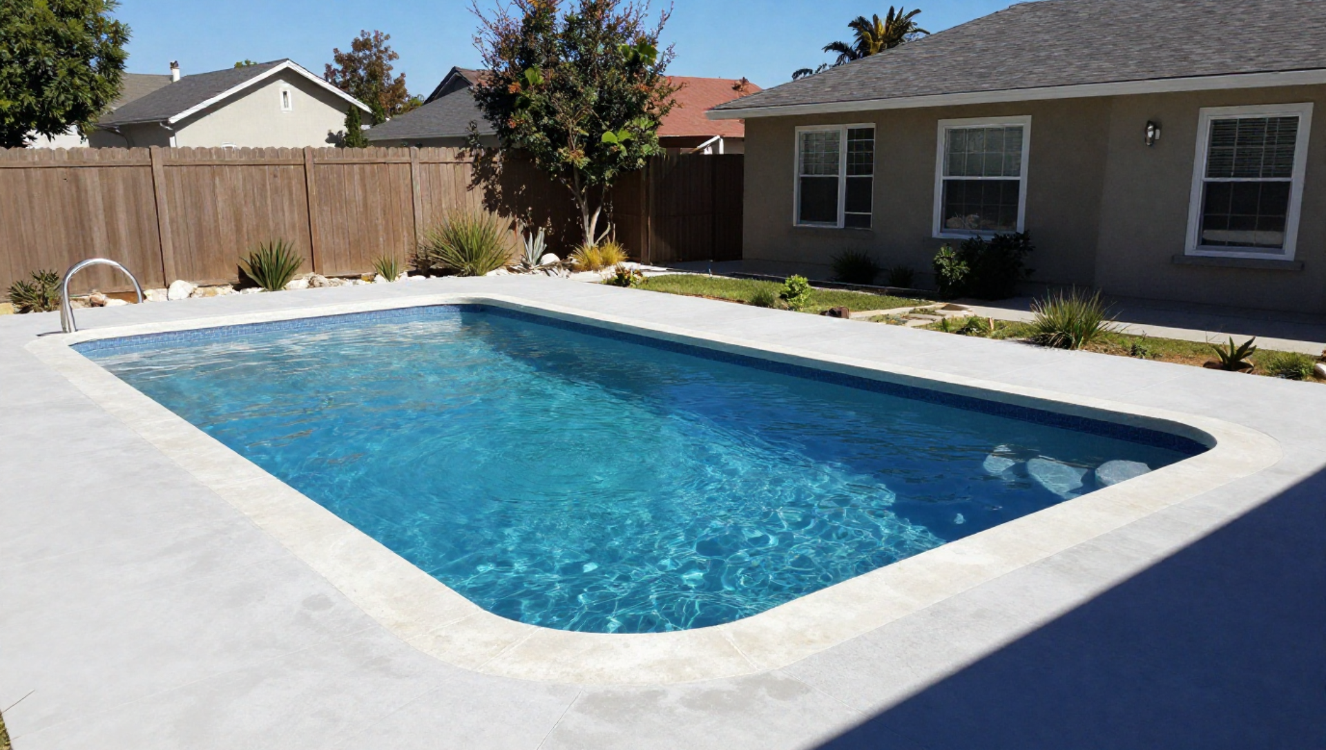 A man is cleaning a swimming pool with a mop.