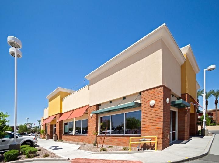 A large brick building with a lot of windows and awnings