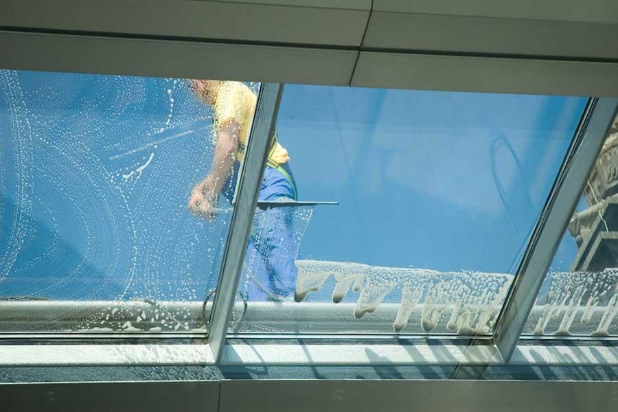 Man washing and squeegeeing a skylight