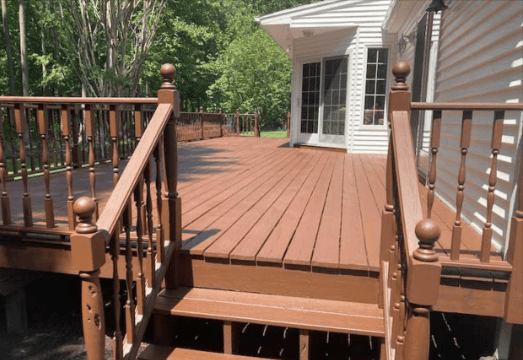 A wooden deck with stairs leading up to it