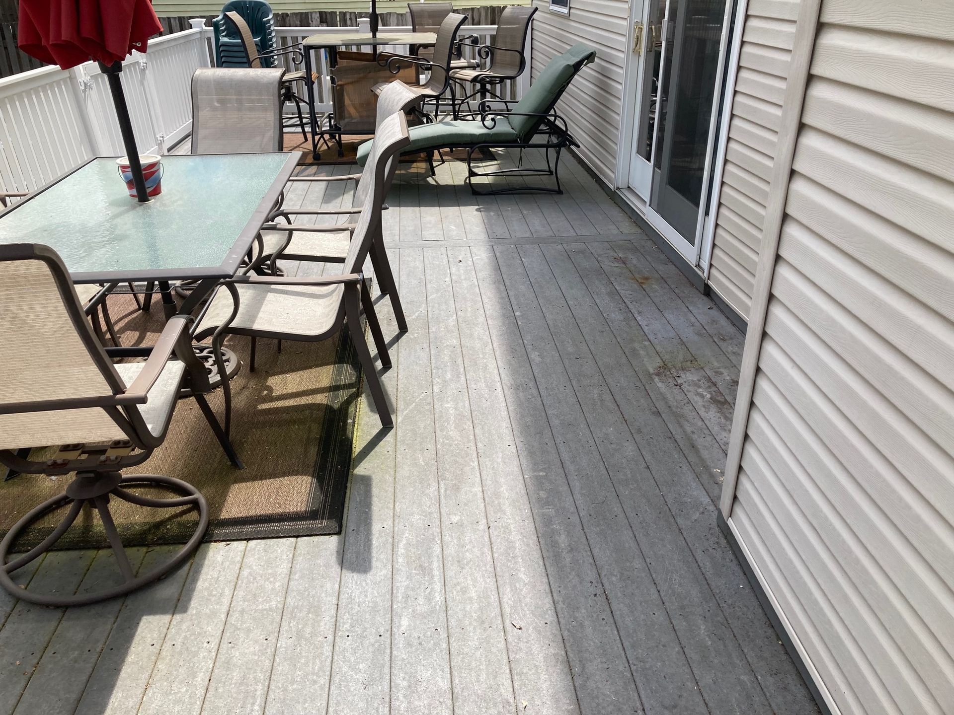 A wooden deck with a table and chairs on it
