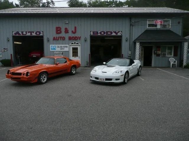 Orange and white sports cars parked outside B&J Auto Body garage