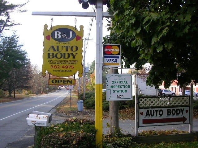 B&J Auto Body roadside sign and entrance with official inspection sign and Visa stickers