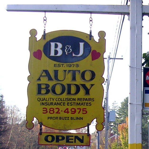 Yellow hanging sign for B & J Auto Body, quality collision repair, with “OPEN” below