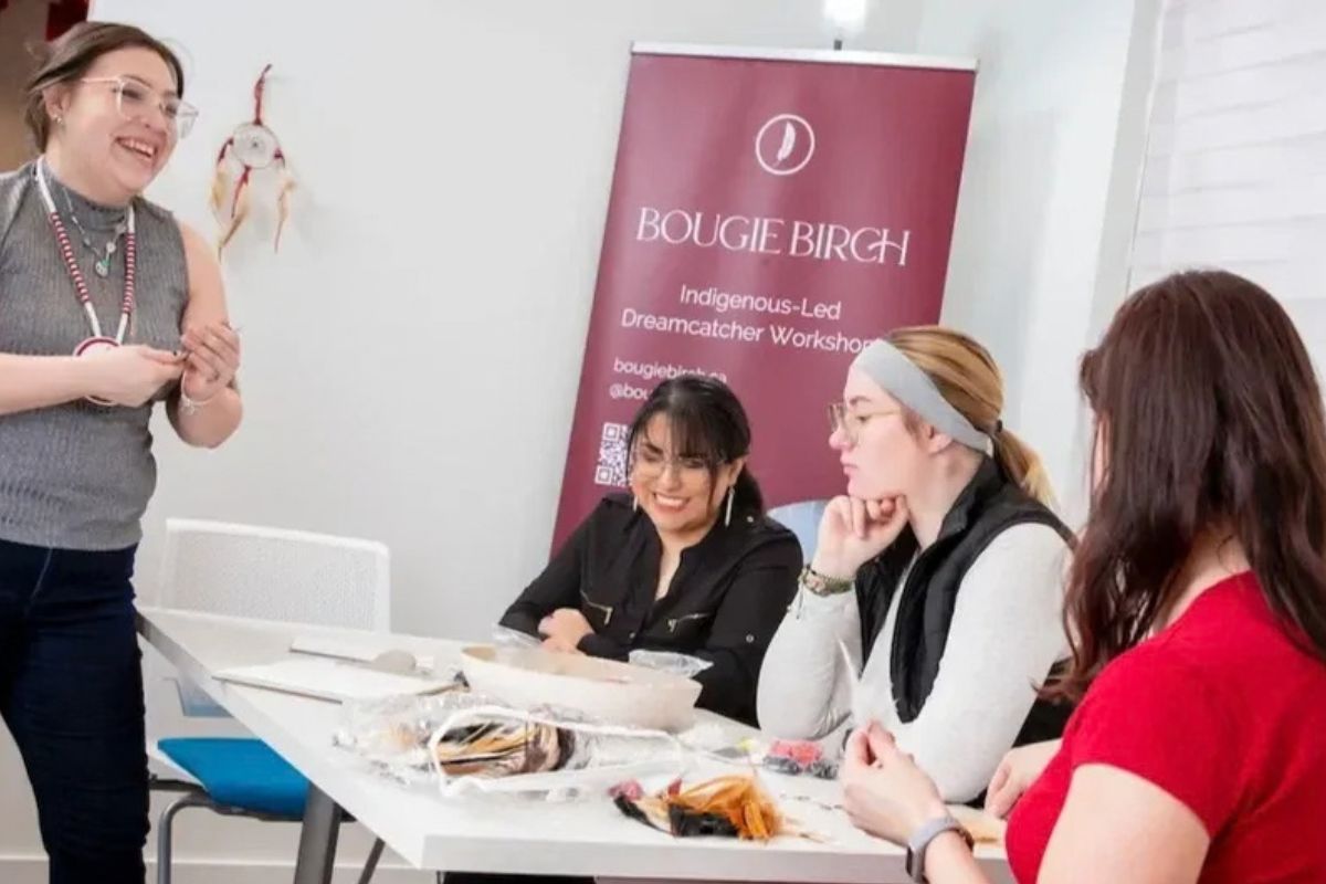 People crafting at a table with a banner that reads 