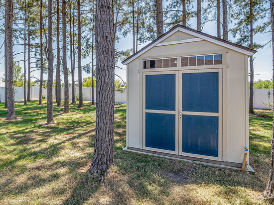 A shed in the backyard of a home that was placed using a crane.